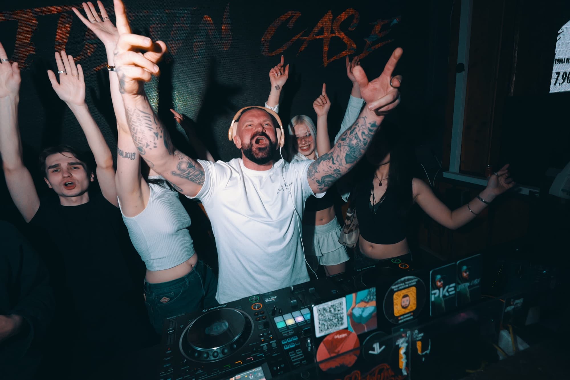 DJ Justin Case on stage, crowd with hands up